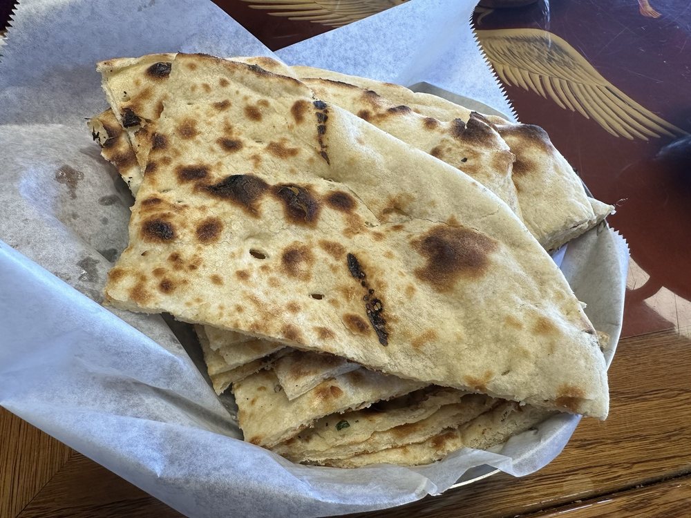 Stacked flatbread pieces inside a serving basket.