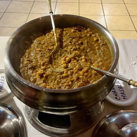 Deep metal catering pot filled with traditional minced meat dish.